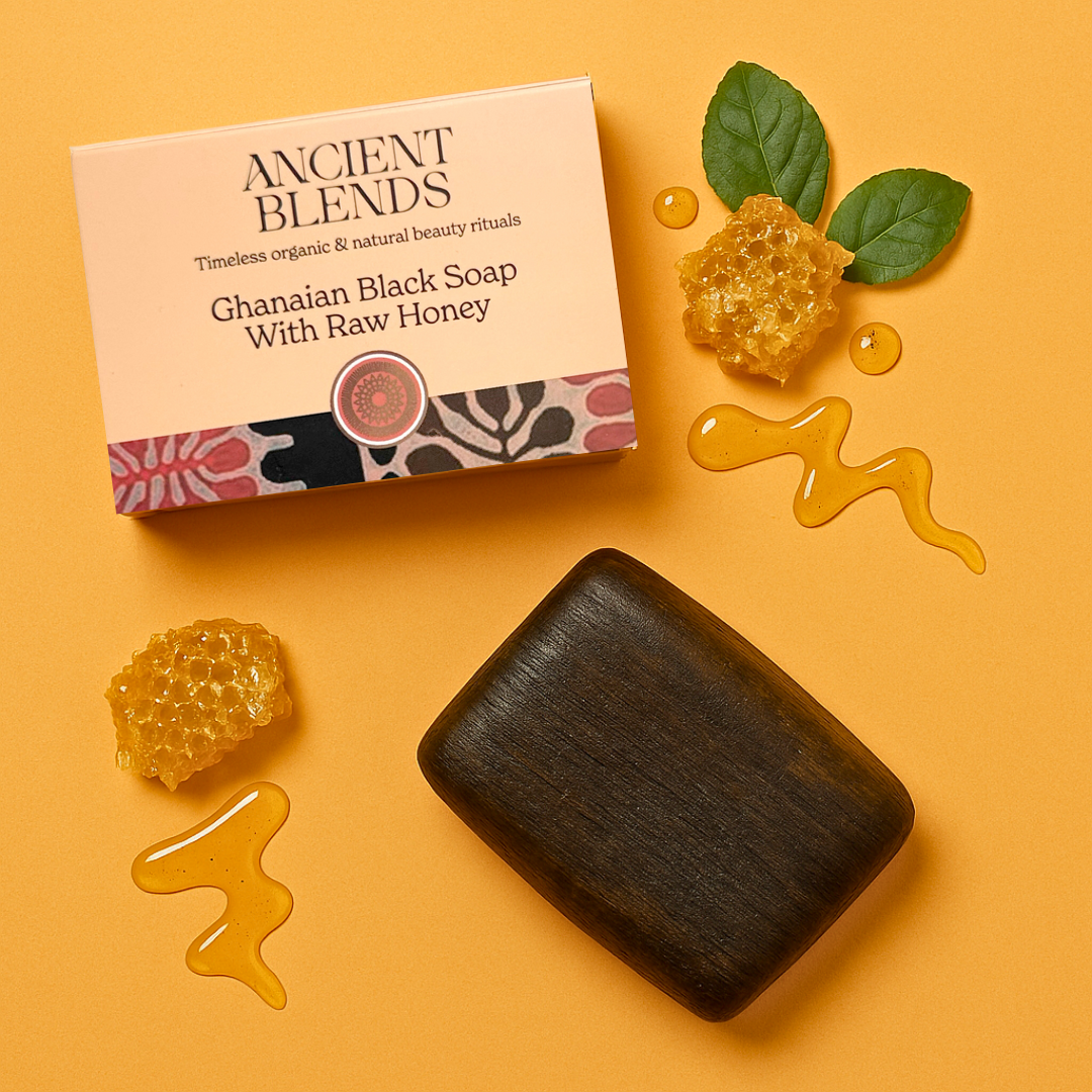 Packaged Ghanaian black soap with a green label featuring leaf patterns and product name details.