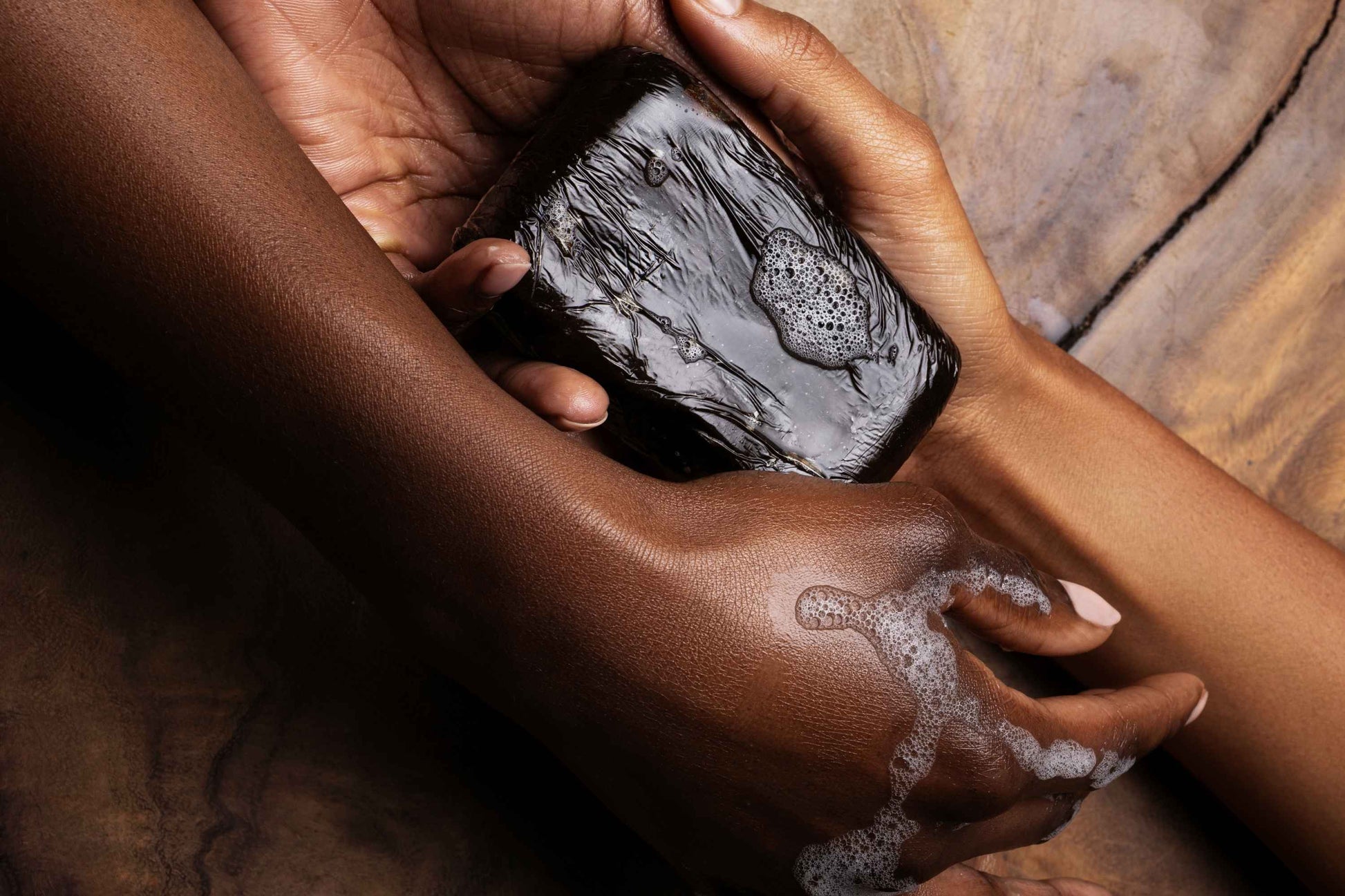 Ancient Blends Ghanaian Black Soap with Raw Honey in Hands